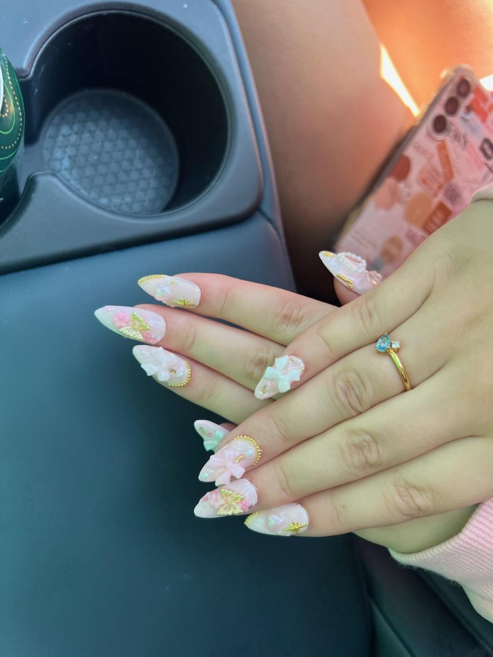 Pink bow nail set worn on hands